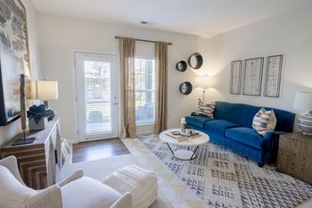 A living room with a blue couch and a coffee table.